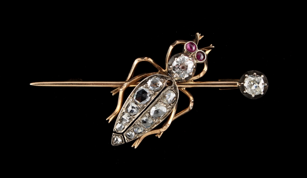 An unmarked gold diamond bug brooch, set with two Old European cut diamonds, eleven graduated rose