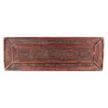 A Tibetan carved gilt & red painted wood rectangular book cover, 19th century or earlier, 28.35 by