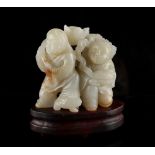 A Chinese carved pale jade group of Liu Hai with attendant, probably late 19th / early 20th century,