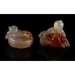 Two Chinese agate carvings, one depicting a man & boy with a drum & kitten, the other depicting a