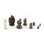A graduated set of six bronze opium weights, the largest 2.7ins. (6.8cms.) high; together with a