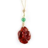 A Chinese carved amber pendant modelled as fruit & leaves, probably 19th century, on string necklace