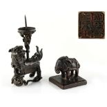 A small Chinese bronze pricket candlestick, Ming Dynasty (1368-1644), modelled as a temple lion with
