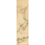 An early 20th century Chinese scroll painting on paper depicting a scholar & boy standing by