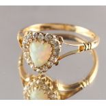A late Victorian 18ct yellow gold opal & diamond ring, the heart shaped opal in conforming setting