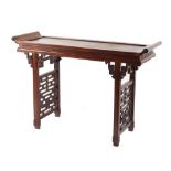 A Chinese carved hongmu altar table, late 19th century, 50ins. (127cms.) long (see illustration).