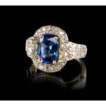 A very fine platinum sapphire & diamond cluster ring, of buckle form, the certificated untreated