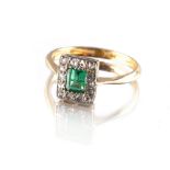 An 18ct yellow gold emerald & diamond ring, the rectangular cut emerald of clear vibrant colour