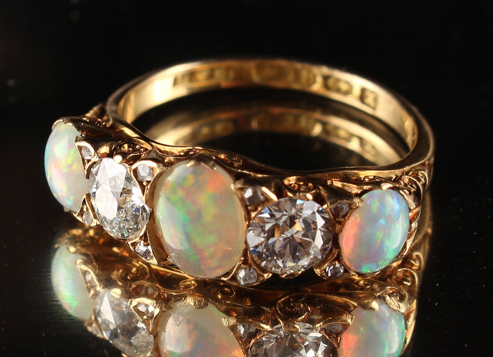 A late Victorian 18ct yellow gold opal & diamond five stone ring, with three oval opals