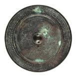 Property of a lady, acquired in the 1980's or early 1990's - a Chinese bronze mirror, late Western