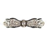 An Art Deco diamond & black onyx ribbon brooch, circa 1930, in yellow gold & platinum setting, 2.