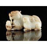 Property of a lady - a large Chinese carved white jade model of a recumbent luduan with two cubs,