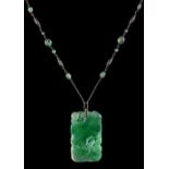 A large Chinese carved jadeite lotus pendant with diamond set suspension loop, on later associated