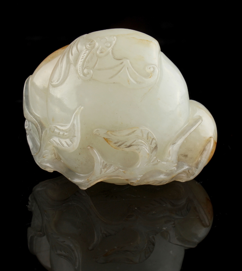 A Chinese very pale celadon carving of a bat & three peaches, the stone with russet markings, 1.