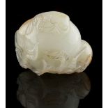 A Chinese very pale celadon carving of a bat & three peaches, the stone with russet markings, 1.