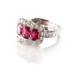 A fine platinum ruby & diamond ring, with three certificated untreated Burmese cushion cut rubies