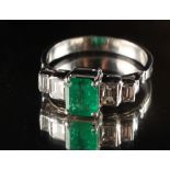 An Art Deco style unmarked white gold emerald & diamond ring, the octagonal cut Colombian emerald