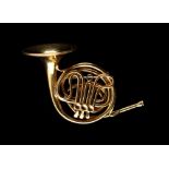 Cartier - an 18ct yellow gold brooch modelled as a French horn, hallmarked Jacques Cartier, London