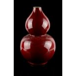 A Chinese copper red glazed double gourd vase, 18th / 19th century, slightly reduced in height &