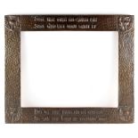 An Arts and Crafts copper rectangular frame embossed with a verse after Robert Burns 'Some hae