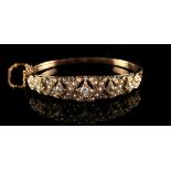 A late Victorian yellow gold diamond & seed pearl hinged bangle, with five graduated Old European