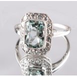 An Art Deco unmarked white gold or platinum aquamarine & diamond ring, the octagonal cut