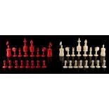 A private collection of chess sets - a 19th century red stained & natural carved bone chess set, the