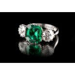 Property of a lady - an unmarked white gold or platinum synthetic emerald & diamond three stone