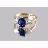 An 18ct yellow gold certificated untreated sapphire & diamond three stone ring, the cushion cut