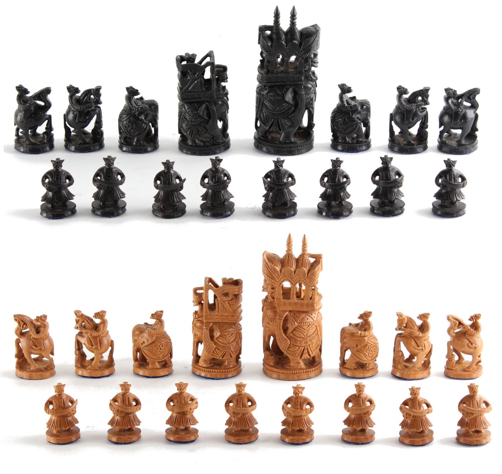 A private collection of chess sets - an Indian carved wood chess set, the kings 4.8ins. (12.5cms.)