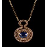 A yellow gold sapphire & diamond pendant necklace, the oval cabochon sapphire weighing an