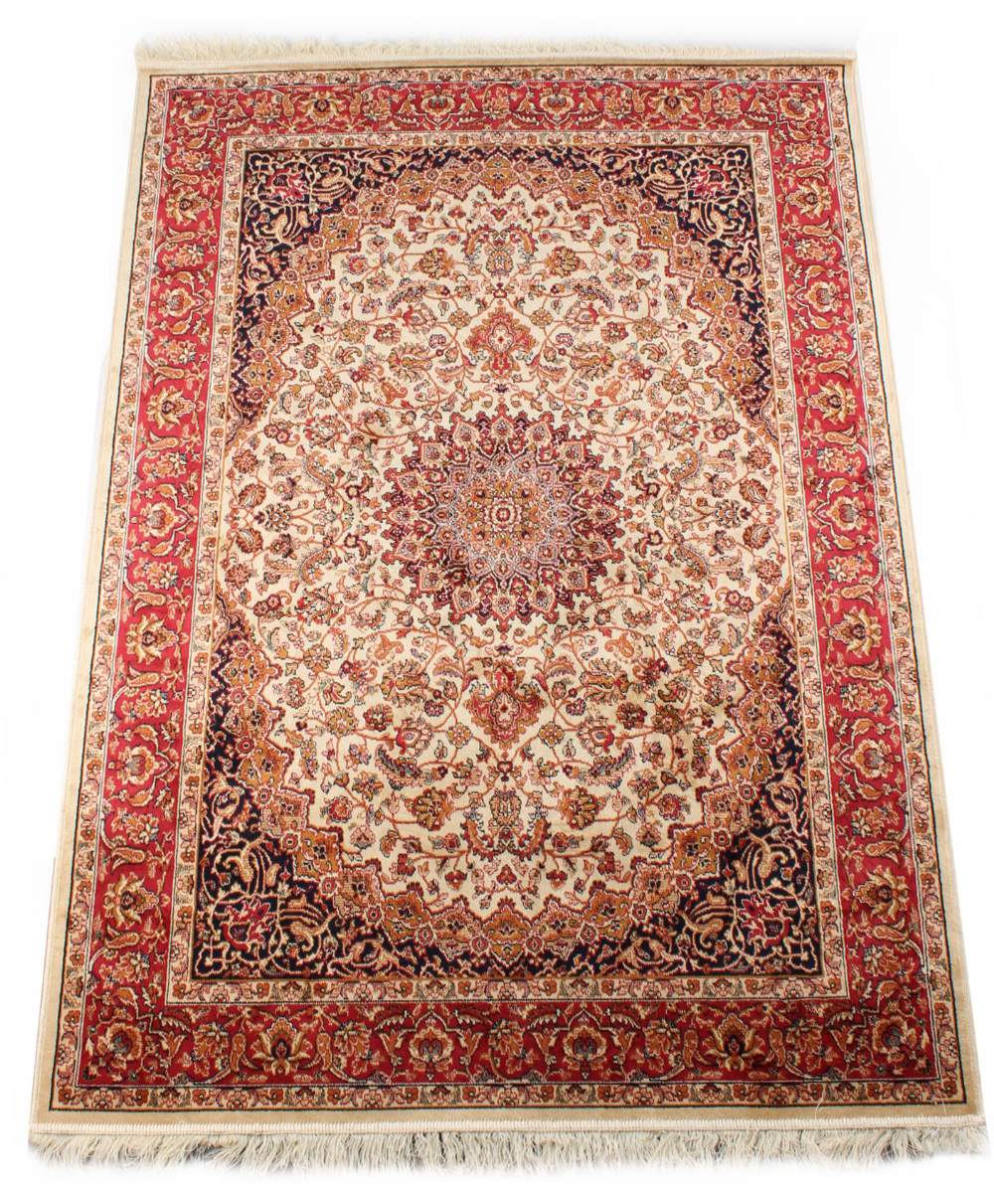 A Kashan style rug with ivory ground, 75 by 53ins. (190 by 135cms.) (see illustration).
