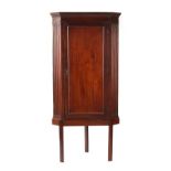 Property of a gentleman - a George III mahogany single door corner wall cabinet, with dentil