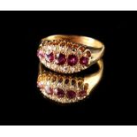An early 20th century 18ct yellow gold ruby & diamond ring, with five graduated round cut rubies