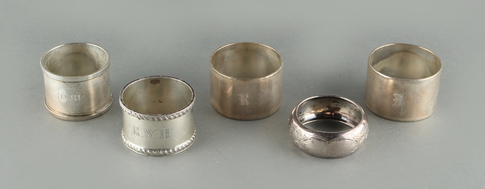Property of a lady - a pair of heavy silver napkin rings; together with three other silver napkin