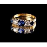 An 18ct yellow gold sapphire & diamond five stone ring, the three round cut sapphires weighing an