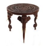 Property of a lady - an Indian carved teak circular topped table with carved elephant monopodiae
