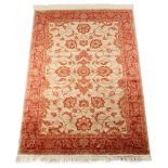 A Ziegler style rug with beige ground, 75 by 53ins. (190 by 135cms.) (see illustration).
