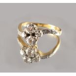 Property of a lady - an 18ct yellow gold diamond crossover style ring, set with two pairs of round