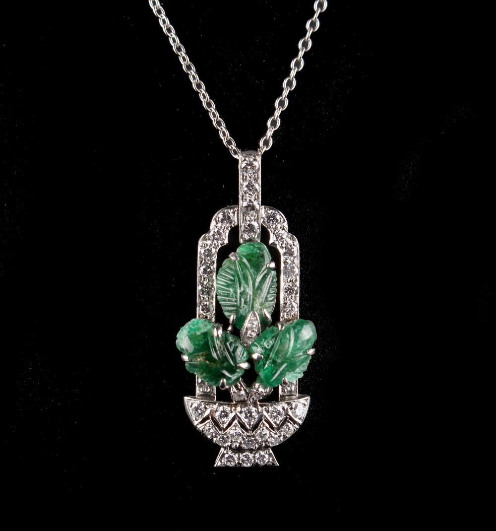 An early 20th century tutti frutti style carved emerald & diamond pendant modelled as a basket of