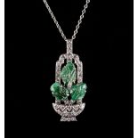 An early 20th century tutti frutti style carved emerald & diamond pendant modelled as a basket of