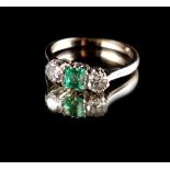 An 18ct white gold & platinum emerald & diamond three stone ring, the square cut emerald weighing