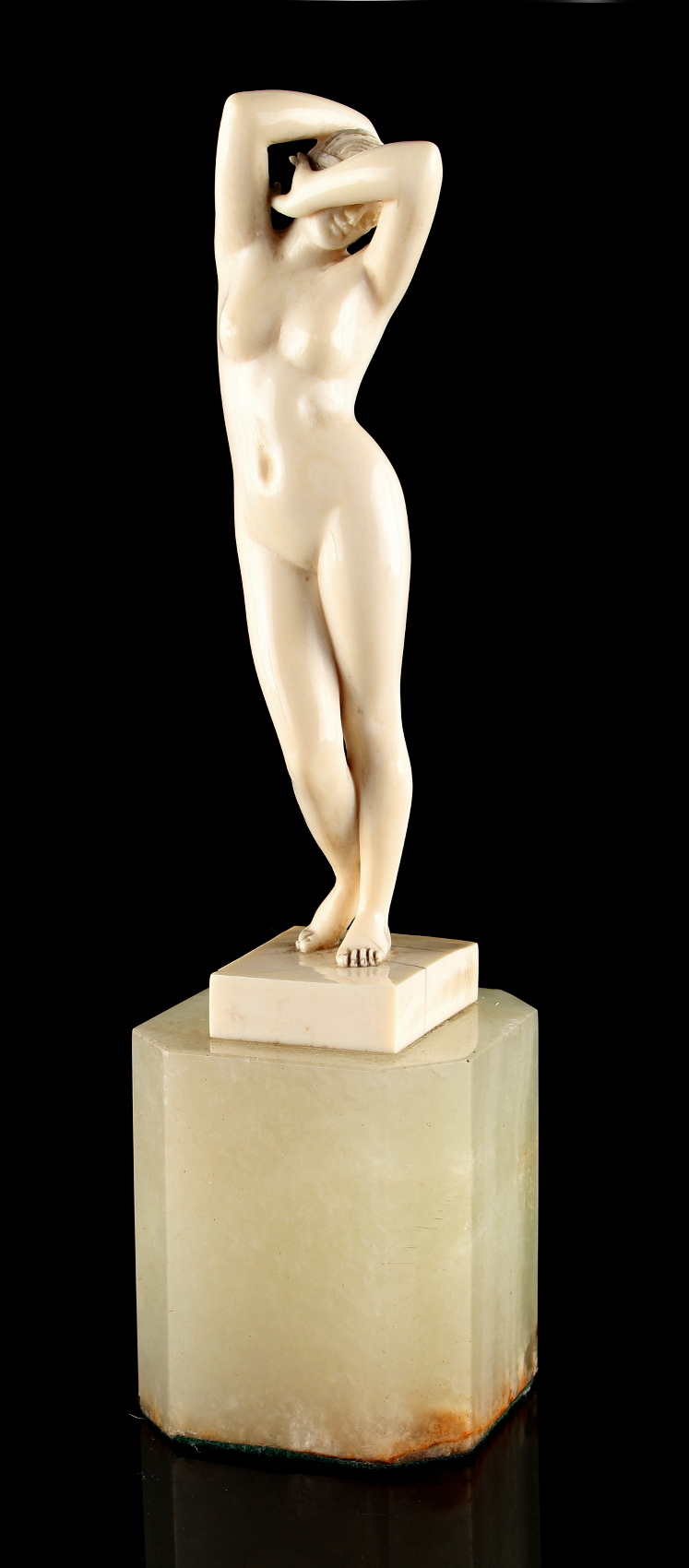 Property of a gentleman - an Art Deco carved ivory figure of a standing female nude, on green onyx