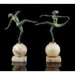 Two similar Art Deco olive green painted spelter figures of female dancers, on alabaster ball bases,