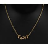 Property of a deceased estate - a 18ct yellow gold & diamond leaf necklace, set with twelve