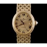 Property of a lady - a lady's Baume & Mercier 18ct yellow gold oval cased automatic wristwatch