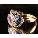 An attractive yellow gold pink sapphire, blue sapphire & diamond twin heart ring, with a pear shaped