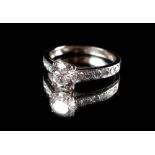 A platinum or white gold certificated diamond solitaire ring, the round brilliant cut diamond