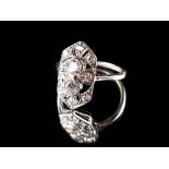 An Art Deco platinum diamond ring, with two round brilliant cut diamonds in collets in a pierced