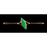 A Chinese yellow gold & jadeite bar brooch, with navette shaped stone, 2.3ins. (5.9cms.) long,